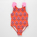 Orange swimsuit with pink floral pattern on a white background