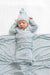 Newborn baby swaddled in a blue and white striped blanket with matching hat.