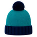 A teal and navy blue knit beanie hat with a matching navy blue pom-pom on top, shown against a plain white background.