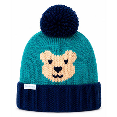A teal and navy blue knit beanie hat with a dark navy pom-pom on top and a knitted bear face on the front. The bottom cuff is ribbed navy blue, and a small white tag is visible on the side.