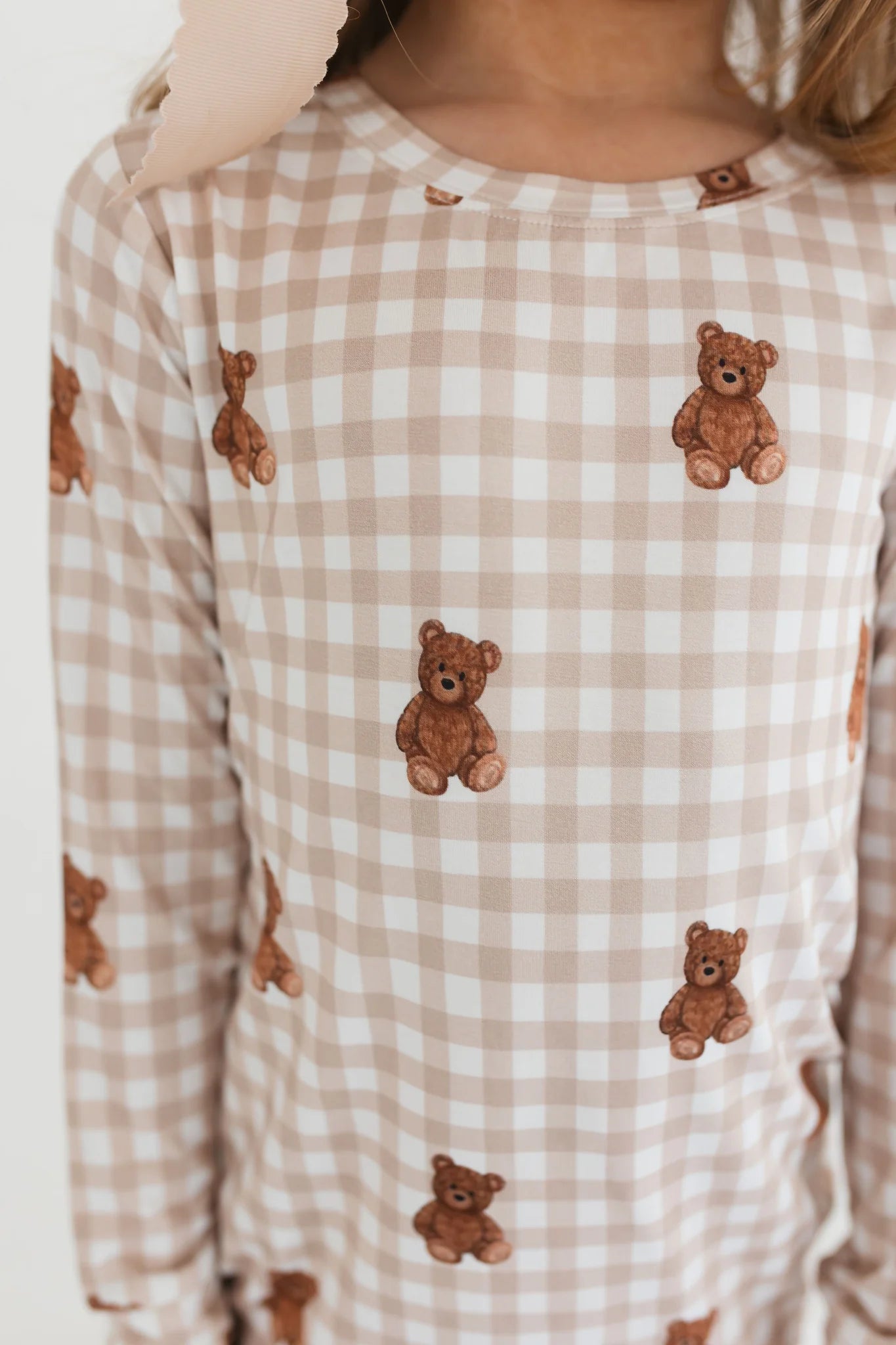 Long-sleeve shirt with teddy bear pattern on a checkered background