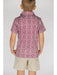 Child wearing a patterned shirt and beige shorts on a plain background
