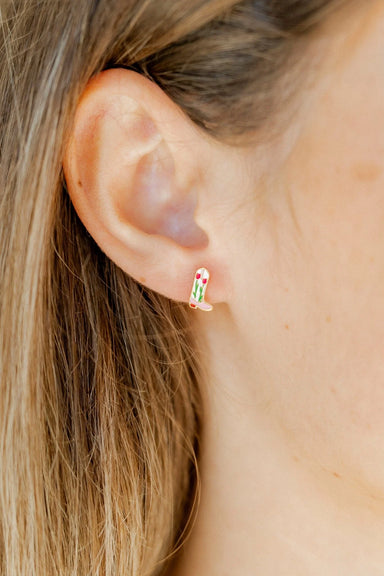 Close-up of an ear wearing a colorful earring with blonde hair.