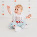 Baby wearing a 'USA' shirt with a star-themed background