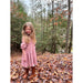 little girl wearing rose colored dress with ruffled 3/4 sleeve and gathered bodice