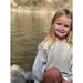 little girl wearing grey sweater with white ruffle on bottom and 3/4 sleeve