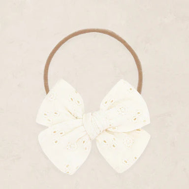 Vanilla eyelet headband on a beige background
