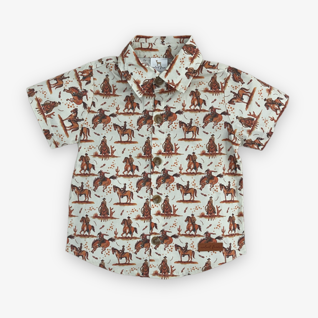 cream colored short sleeve button down shirt with brown rodeo print