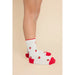 White ribbed crew socks with red toes, heels, and cuffs, decorated with small embroidered red strawberries, shown on a model's feet against a solid beige background.