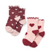 Two pairs of children's socks on a white background. One pair is dark burgundy with small white hearts and a light pink toe and heel, featuring a ruffled cuff.