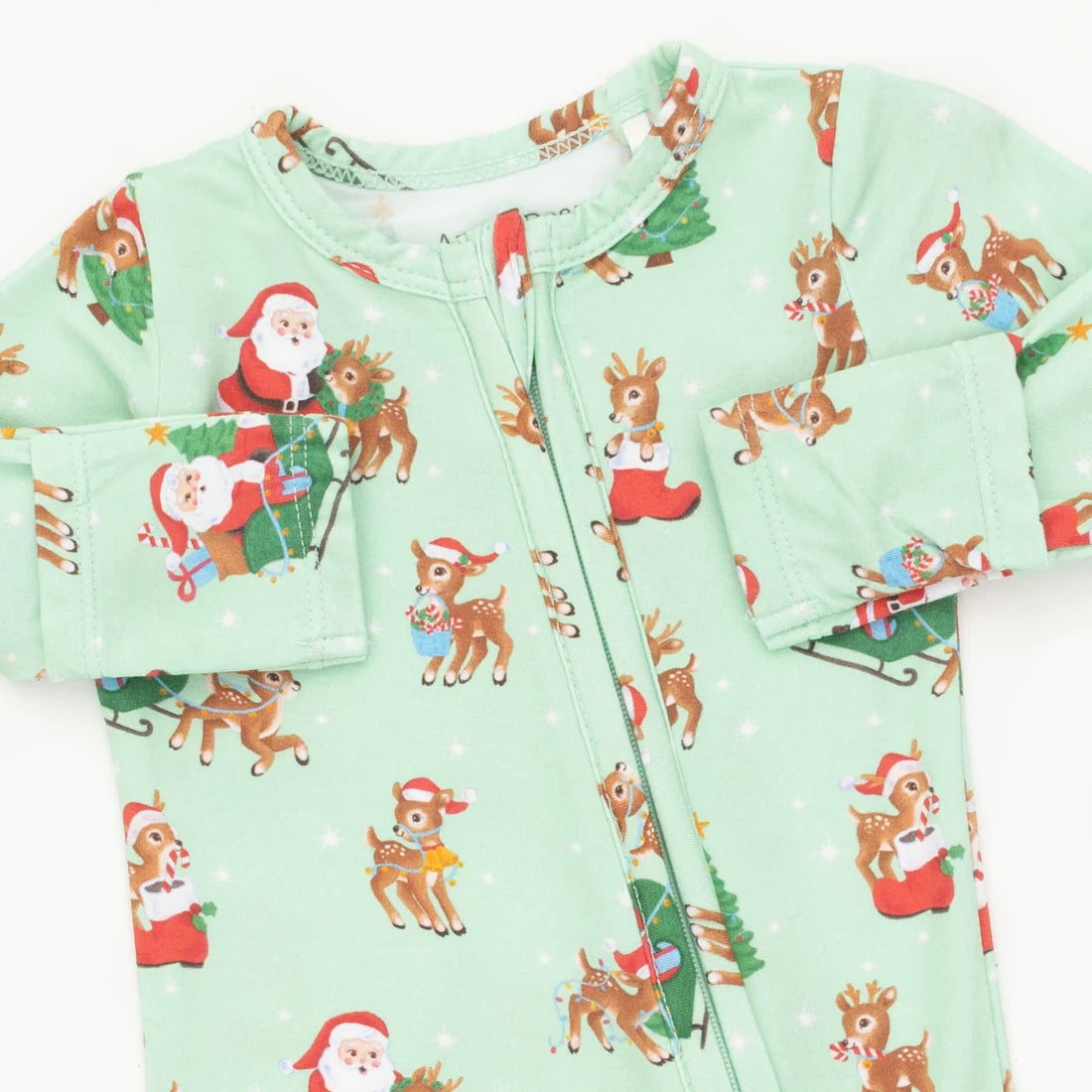 A long-sleeve baby zip-up sleeper in light mint green, featuring a festive Christmas print with Santa Claus, reindeer, and snowflakes.