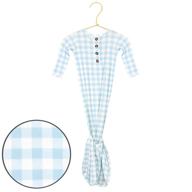 Blue and white checkered knotted gown on a hanger with a close-up inset showing fabric texture.