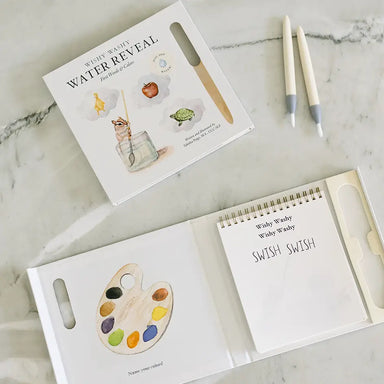 Children's art book with watercolor illustrations on a marble surface
