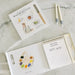 Children's art book with watercolor illustrations on a marble surface