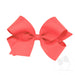 Large coral bow on a white background