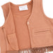 A close-up of a toddler's sleeveless vest in a mocha color, featuring a single button closure, a chest pocket, and fringe trim along the hem. The brand label reads 'Angel Dear'.
