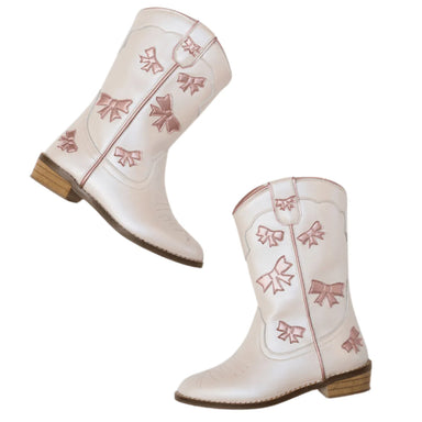 White cowboy boots with pink bow designs on a white background