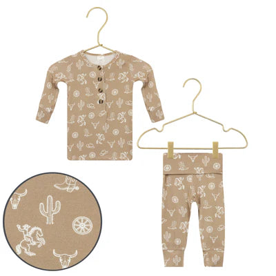 Children's pajama set with cowboy pattern on a white background