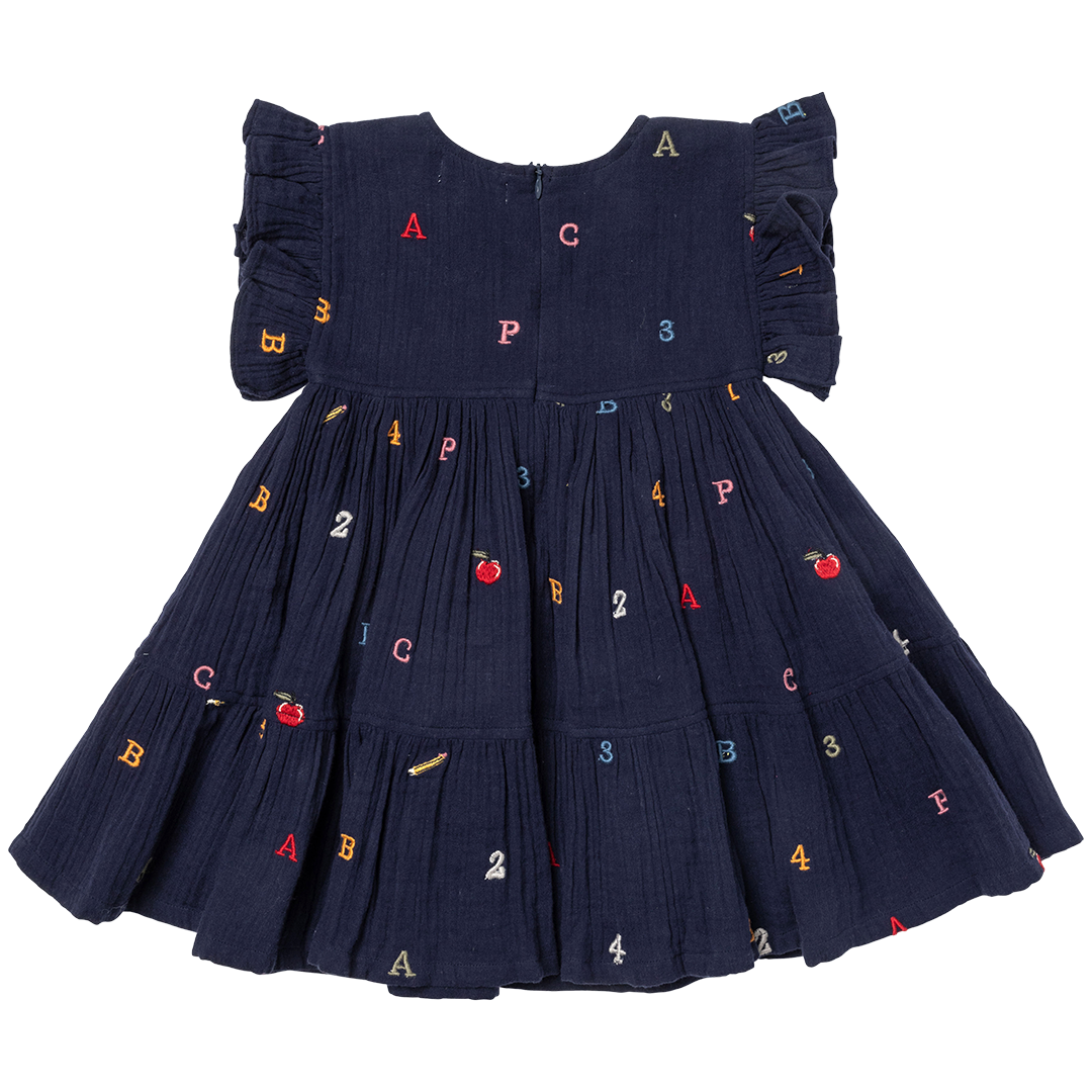 back of navy dress with multicolored alphabet letters embroidered and applies