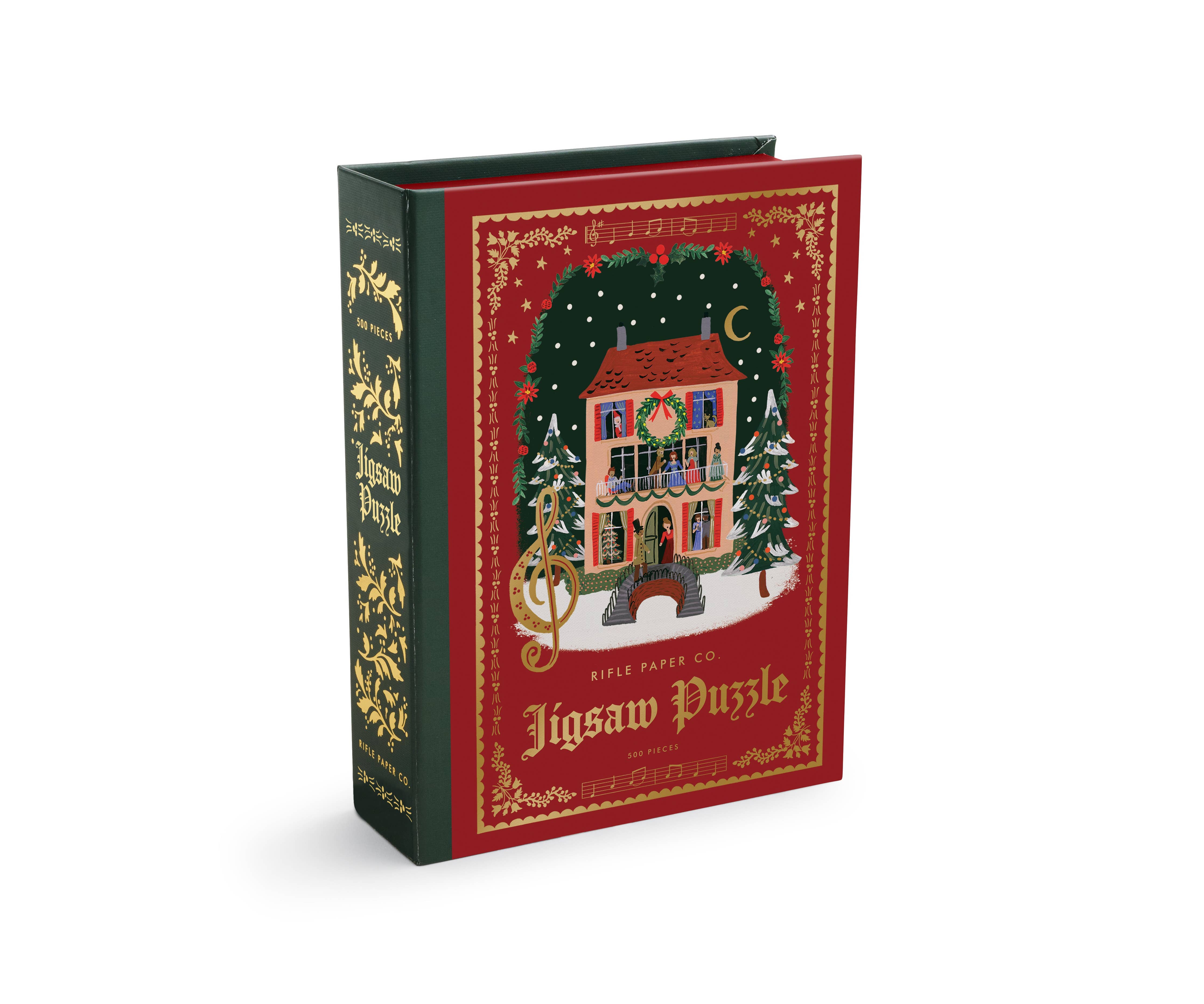 Rifle Paper Co. Christmas puzzle box designed like a storybook with festive carol illustrations a decorated red cover and illustrated spine