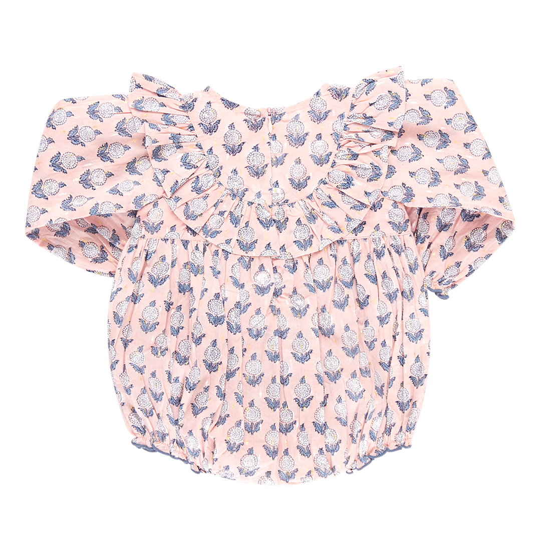 back of pink long sleeve ruffle bubble with blue and white dahlia block print