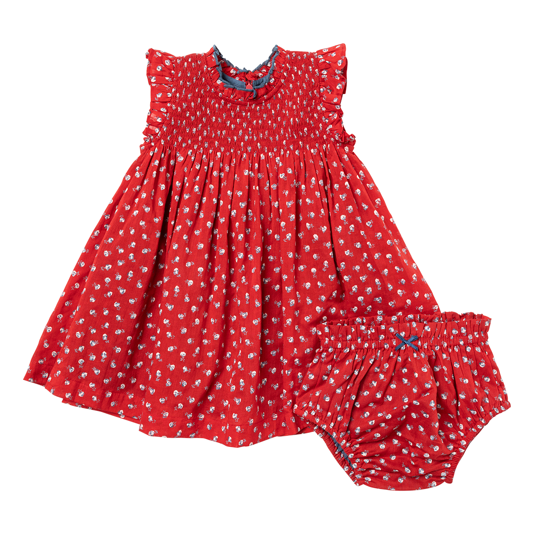 red sleeveless dress with smocking at the chest and tiny white rose print and matching bloomers