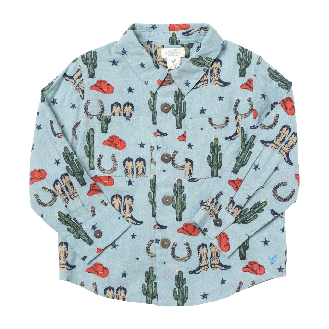 light blue long sleeve button down with rodeo print including cowboy boots, cactuses and cowboy hats