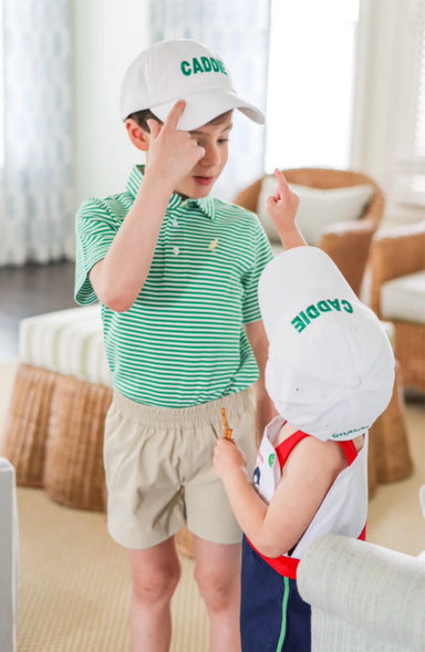 Two children wearing Cadie hats indoors with a blurred background