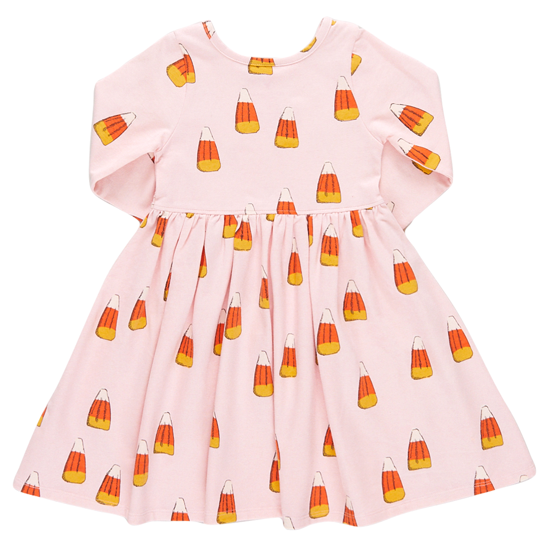 back view of pink long sleeved dress with orange, yellow and white candy corn print