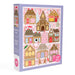 Pippi Post 500 piece Christmas jigsaw puzzle box featuring a colorful gingerbread village with candy shop cafe toy shop bookstore and post office