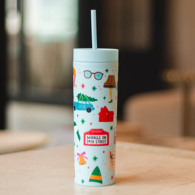 Pippi Post Christmas movie themed 16 ounce skinny acrylic tumbler with straw and illustrated holiday icons on a pale background