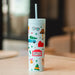 Pippi Post Christmas movie themed 16 ounce skinny acrylic tumbler with straw and illustrated holiday icons on a pale background
