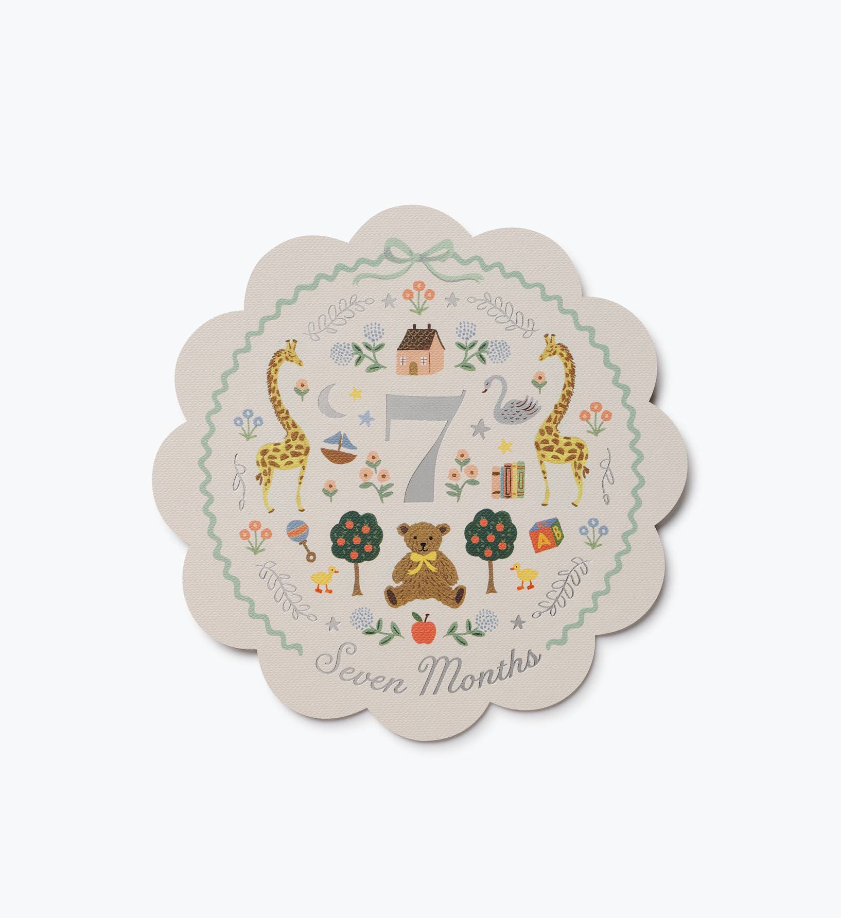 Illustrated seven month baby milestone card with giraffes bears flowers and a scalloped edge from Rifle Paper Co.