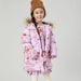girl wearing lavender purple puffer with orange poppy print and faux fur hood