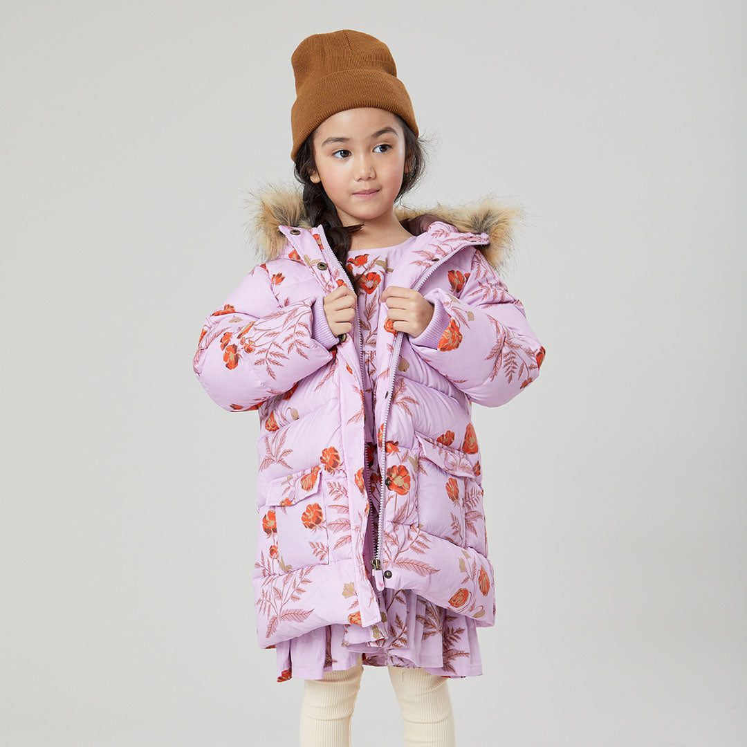 girl wearing lavender purple puffer with orange poppy print and faux fur hood