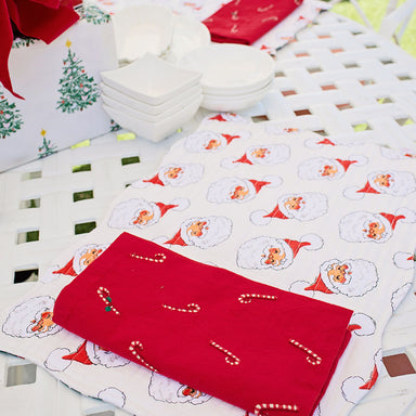 quilted white placemats with vintage santa print paired with red candy cane napkin