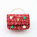 Red textured handbag with Christmas-themed decorations on a white background
