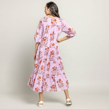 back of woman wearing lavender 3/4 sleeve midi dress with orange poppy print